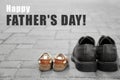 Big and small shoes on pavement outdoors. Happy Father's Day celebration