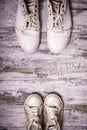 Big and small shoes on wooden background. Still life photography : father and child shoes on old wood in vintage color tone, go Royalty Free Stock Photo