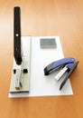 Big and small staplers with staples and paper Royalty Free Stock Photo