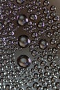 Big and small water drops on glass against dark background Royalty Free Stock Photo