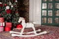 Big and small wooden toy horses standing under the christmas tree Royalty Free Stock Photo