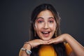 Big smiles here. Cropped portrait of an attractive teenage girl standing alone against a dark studio background with her Royalty Free Stock Photo