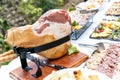 Big smoked leg on the table. Banquet jamon.outdoor banquet table with many snacks and delicacies Royalty Free Stock Photo