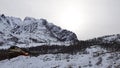 Big snow covered mountain near Holdoya on Hinnoya in winter in Norway