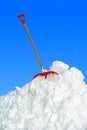 Big snow heap and shovel, blue sky
