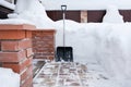 Big snow shovel is next to snowdrifts. Soft focus.ÃÂ¡oncept of cleaning a large amount of snow from sideway