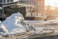 Big snowdrift on city street after heavy snowfall in winter. Heap of dirty snow near office building, blizzard aftermath. Weather Royalty Free Stock Photo