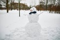 Big snowman with happy face, carrot nose and scarf on a winter day Royalty Free Stock Photo