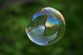 Big soap bubble on green Royalty Free Stock Photo