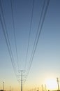A big solo power line and pole in the blue and yellow sky Royalty Free Stock Photo
