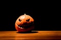 Lonely halloween pumpkin smile with black dark fire eyes mouth