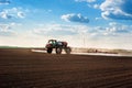 Big sprayer with long arms at the arable field makes fertilizers in early spring Royalty Free Stock Photo