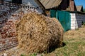 Big stack of dry hay near the brick wall in the village Royalty Free Stock Photo