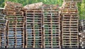 Big stack of lots of wooden pallets for transport or shipping forklift lifting cart pallet truck