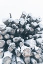 Big stack of snow covered pine logs. Vertical layout Royalty Free Stock Photo