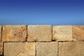 Big stone bricks masonry wall on port blue sky