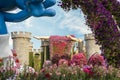 Big stone fairytale castle with a sleeping beauty in botanical Dubai Miracle Garden with different floral fairy-tale themes in