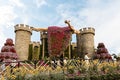 Big stone fairytale castle with a sleeping beauty in botanical Dubai Miracle Garden with different floral fairy-tale themes in Royalty Free Stock Photo