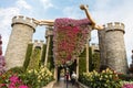Big stone fairytale castle with a sleeping beauty in botanical Dubai Miracle Garden with different floral fairy-tale themes in Royalty Free Stock Photo