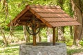 Big stone well with a roof in the middle of a forest Royalty Free Stock Photo