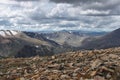 Big stones on the background of valley and high mountain snow peaks ranges Royalty Free Stock Photo