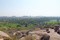 Big stones in Hampi, Karnataka, India. Beautiful green valley of rice fields and palm trees