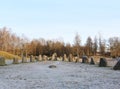 The big stones standing in the snow field in winter