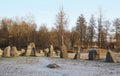 The big stones standing in the snow field in winter