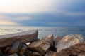 Big stones wall near sea in sunset Royalty Free Stock Photo