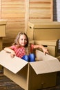 Big storage space. Relocating family stressful for kids. Kid girl relocating boxes background. Relocating concept