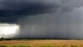 Big storm with rain coming down from the clouds - black clouds and rain over the field - storm landscape - rainy season Royalty Free Stock Photo