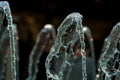 Big and strong water jets from the fountain with blue illumination in shopping center. Splashes and drops. Royalty Free Stock Photo