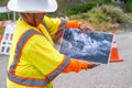 BIG SUR, CA - AUGUST 3, 2017: Woman shows winter landslide damage in Cabrillo Highway. The road is still under construction Royalty Free Stock Photo