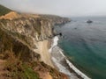 Big Sur California coast, bridge, beach, rocks, clouds, and surfing waves Royalty Free Stock Photo