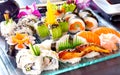 Big sushi set with maki, nigiri, dragon rolls. Sushi with salmon, tuna, raw fish, on a blue, glass plate. Royalty Free Stock Photo