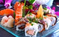 Big sushi set with maki, nigiri, dragon rolls. Sushi with salmon, eel, tuna, raw fish, on a blue, glass plate. Royalty Free Stock Photo