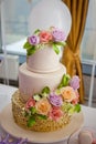 Big sweet multilevel wedding cake decorated with flowers. Concept of candy bar on party Royalty Free Stock Photo