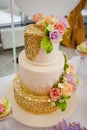 Big sweet multilevel wedding cake decorated with flowers. Concept of candy bar on party Royalty Free Stock Photo