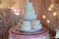 Big sweet multilevel wedding cake decorated with flowers. Concept of candy bar on party Royalty Free Stock Photo