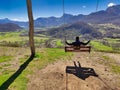 A big swing in pico Caleo, viewpoint over Lario village, MontaÃ±a de RiaÃ±o y Mampodre Regional Park, Leon province, Spain