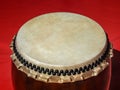 A big Taiko drum o-daiko on isolated red background. Musical percussion instrument of Asia