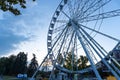 Big tall white Ferris wheel in front of a perfect blue sky Royalty Free Stock Photo