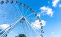 Big tall white Ferris wheel in front of a perfect blue sky Royalty Free Stock Photo