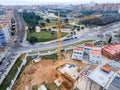 Big tall yellow tower crane over the buildings at a construction site Royalty Free Stock Photo