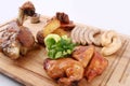 Big tasty baked  knuckle, homemade sausages, grilled bird, potatoes. Royalty Free Stock Photo