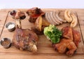 Big tasty baked  knuckle, homemade sausages, grilled bird, potatoes. Royalty Free Stock Photo
