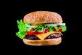 Big tasty hamburger or cheeseburger on black background with grilled meat, cheese, tomato, bacon, onion. Burger Royalty Free Stock Photo