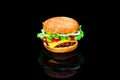 Big tasty hamburger or cheeseburger isolated on black background with grilled meat, cheese, tomato, bacon, onion. Burger Royalty Free Stock Photo