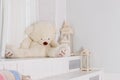 Big teddy bear near big white lantern,pillows in girly room. playroom interior.Beautiful child`s room in pastel tones