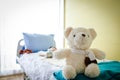 A big teddy bear in a patient`s bed Royalty Free Stock Photo